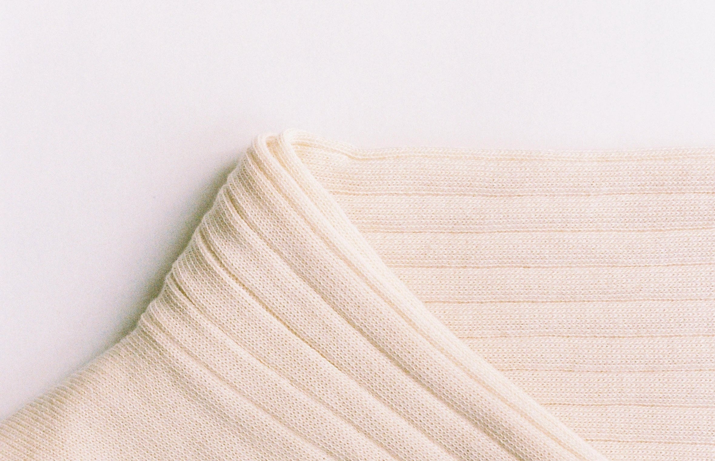 Ivory ribbed sock with 'Dante's' branding on a light grey background