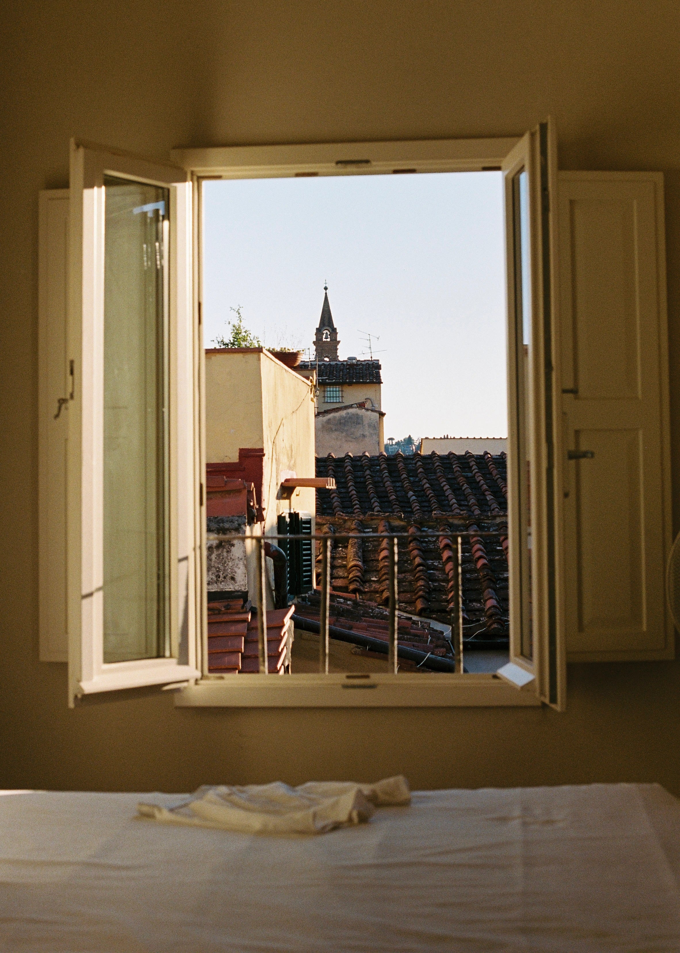 Open window with view of rooftops in florence, Italy. With boxers in the foreground.